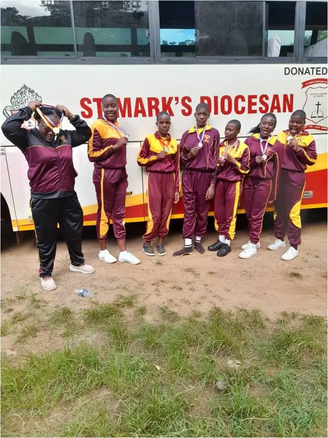 St Mark's students with their medals beside the school bus