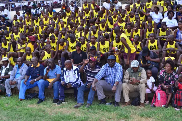 Athletes in team colours gathered with their coaches