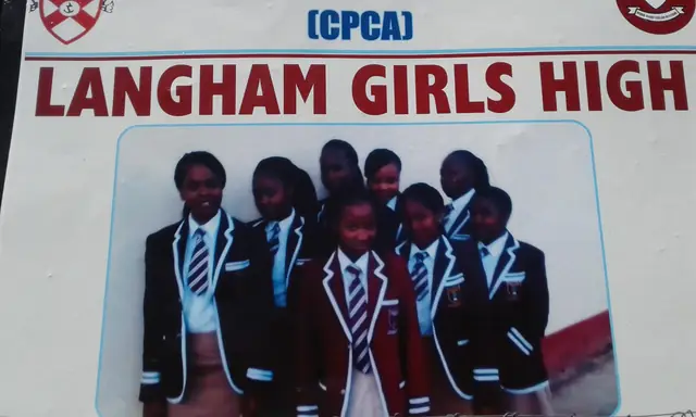 Langham Girls High School students in front of the school sign