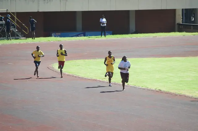 Athletes racing down the home straight of a running track
