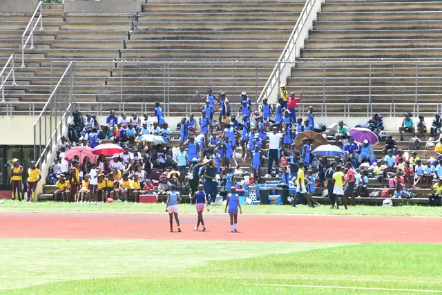 Students filling the stands at an athletics meet