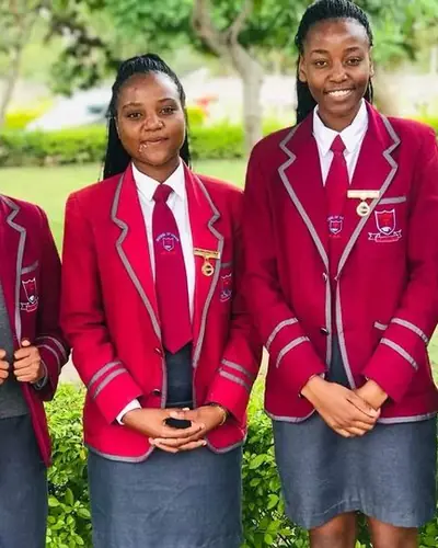 Students in red school blazers standing together outdoors