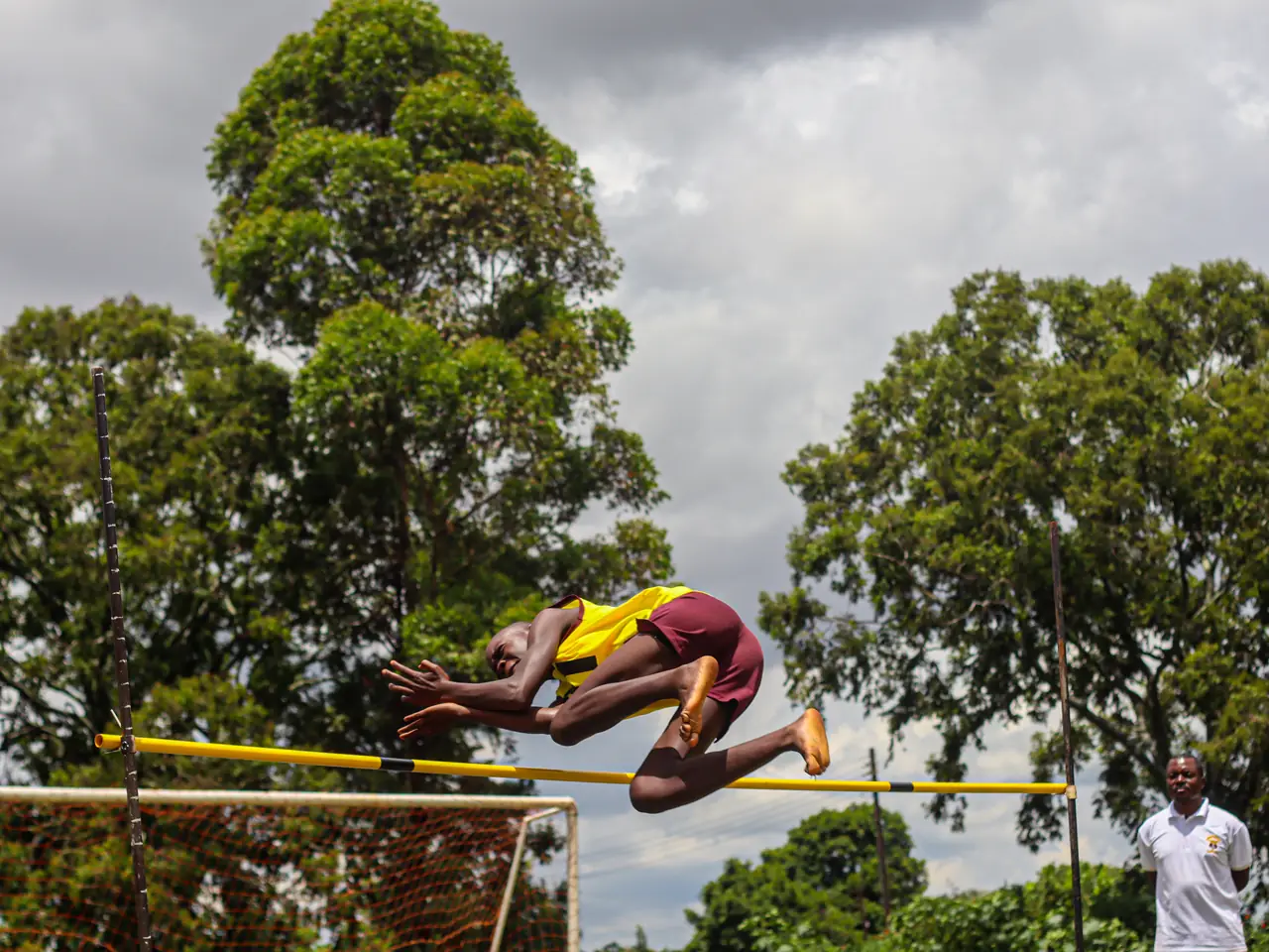 An athlete clearing the high-jump bar at an inter-school sports day
